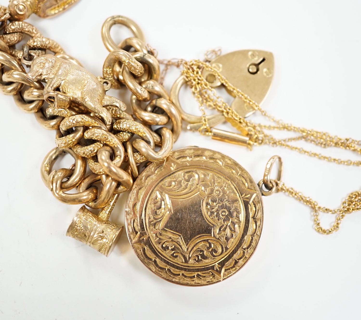 A 9ct gold charm bracelet and a 9ct gold locket with 9ct chain, gross 26 grams.
